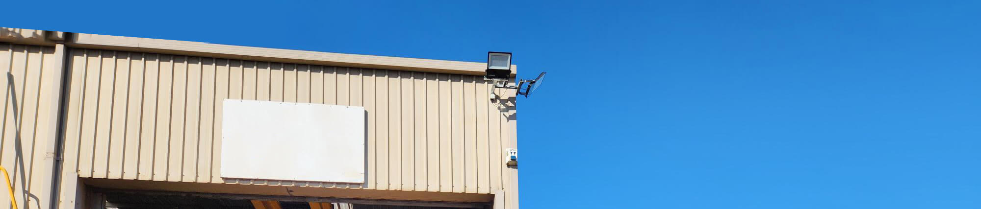 LED flood lights installed on exterior of industrial workshop